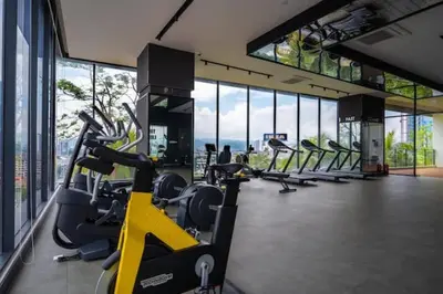 a gym with rows of exercise bikes in a building at Sleek 3BR Suites Near TRX By Rumabnb in Kuala Lumpur