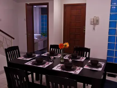 a dining room with a black table and chairs at 5 Twenty @ Ampang Hilir in Kuala Lumpur