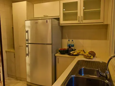 a kitchen with a stainless steel refrigerator and a sink at 5 Twenty @ Ampang Hilir in Kuala Lumpur