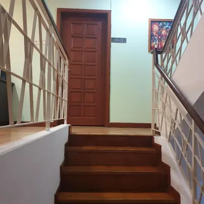 a stairway with a wooden door and a stair case at 5 Twenty @ Ampang Hilir in Kuala Lumpur