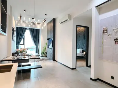 a living room with a dining table and a living room with a couch at OPUS Kuala Lumpur by Scape Stay in Kuala Lumpur