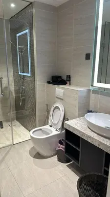 a bathroom with a toilet and a shower and a sink at Star Residence KLCC By M&T in Kuala Lumpur