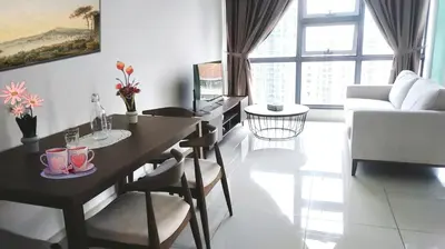 a living room with a table and chairs and a living room at Pool Haven Reservations in Kuala Lumpur