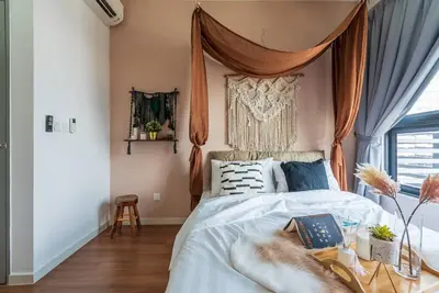 a bedroom with a bed with a canopy at MVB36#Bali Style 3 Rooms Family Suite M Vertica Velocity Mall Cheras in Kuala Lumpur
