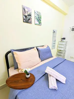 a bedroom with a bed with a wooden table at Private Room with Bathroom in Kuala Lumpur