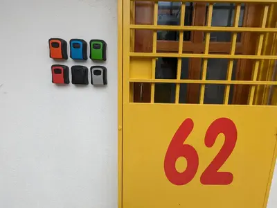 a yellow door with a sign on a wall at Private Room with Bathroom in Kuala Lumpur