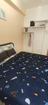 a bedroom with a bed with a blue comforter with fish on it at Hostel Room with Private Bathroom in Kuala Lumpur