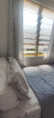 a bedroom with a bed with a window and a pillow at Hostel Room with Private Bathroom in Kuala Lumpur