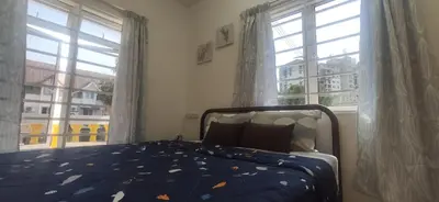 a bedroom with a bed and a large window at Hostel Room with Private Bathroom in Kuala Lumpur