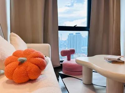 a teddy bear sitting on a couch in a room with a window at V Residence Suites-27 in Kuala Lumpur