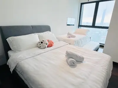a bedroom with two beds with stuffed animals on them at V Residence Suites-27 in Kuala Lumpur