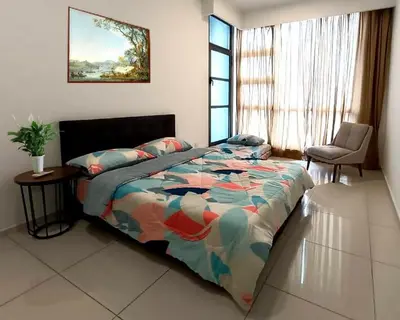 a bedroom with a bed and a chair and a window at 2-Bed Luxury Resort Robertson in Kuala Lumpur