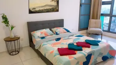 a bedroom with a bed with pillows on it at 2-Bed Luxury Resort Robertson in Kuala Lumpur
