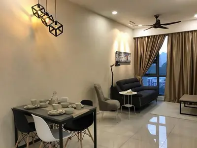 a living room with a table and chairs and a couch at 2-Bed Luxury Resort Robertson in Kuala Lumpur