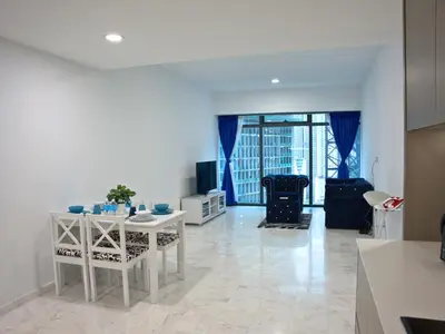 a kitchen and living room with a table and chairs at Eaton Residence Yemala in Kuala Lumpur