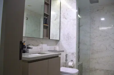 a bathroom with a sink and a toilet and a shower at Eaton Residence Yemala in Kuala Lumpur