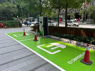 a green parking lot with cones and a parking meter at Dorsett 2BR 6Pax Pavilion Bukit Bintang TRX KLCC in Kuala Lumpur