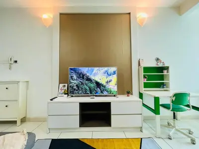 a room with a white desk with a tv on it at Sunway Velocity V Residence by DeUrban in Kuala Lumpur