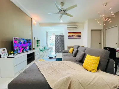 a living room with a couch and a tv at Sunway Velocity V Residence by DeUrban in Kuala Lumpur