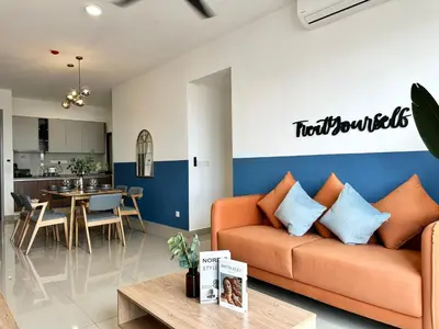 a living room with a couch and a table at M Vertica, Sunway Velocity Kuala Lumpur by Rverse Suite in Kuala Lumpur