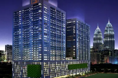 a rendering of a large building in a city at night at Summer Suites KLCC by apartx in Kuala Lumpur