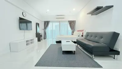 a living room with a couch and a table at Summer Suites KLCC by apartx in Kuala Lumpur