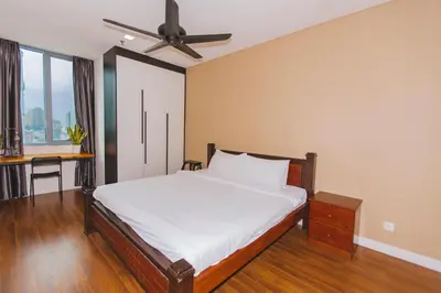 a bedroom with a bed and a ceiling fan at Summer Suites KLCC by apartx in Kuala Lumpur