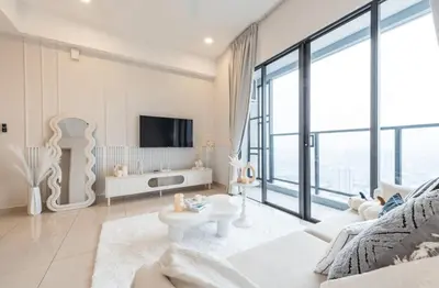 a living room with a couch and a tv at Trion Kuala Lumpur in Kuala Lumpur