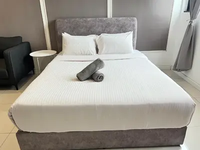 a large bed with a large white comforter at Chambers Residence by Gloria Homes in Kuala Lumpur