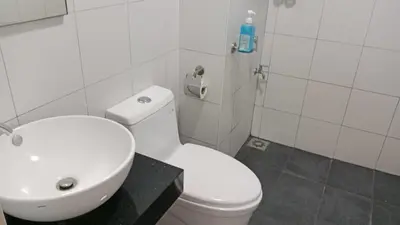 a bathroom with a white toilet and a sink at Chambers Residence by Gloria Homes in Kuala Lumpur