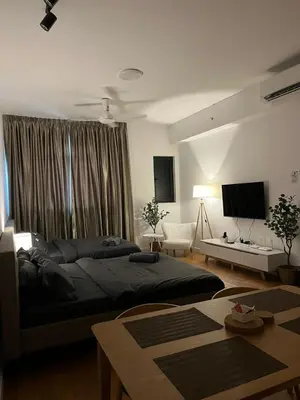 a bedroom with a large bed and a television at Chambers Residence by Gloria Homes in Kuala Lumpur
