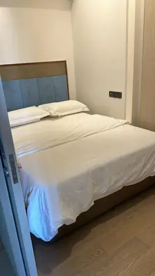 a bedroom with a large bed with white sheets at Star Resident KLCC By M&T in Kuala Lumpur