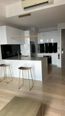 a kitchen with two stools and a counter top at Star Resident KLCC By M&T in Kuala Lumpur