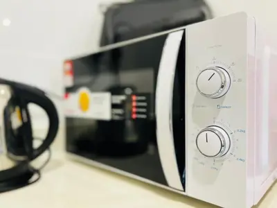 a microwave is sitting on a counter at Arte Mont Kiara by DeUrban in Kuala Lumpur