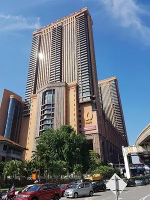 a large building with cars parked in front of it at Bukit Bintang Service Suite at Times Square in Kuala Lumpur