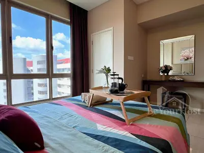 a bedroom with a bed with a table on it at Dorsett Residences Sri Hartamas 5 Star Suites KL in Kuala Lumpur