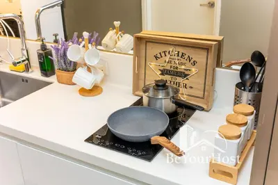 a kitchen counter with a frying pan on a stove at Dorsett Residences Sri Hartamas 5 Star Suites KL in Kuala Lumpur