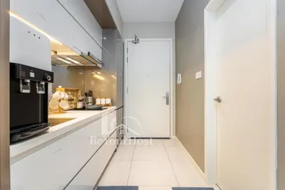 a kitchen with a door leading into a kitchen with a counter at Dorsett Residences Sri Hartamas 5 Star Suites KL in Kuala Lumpur