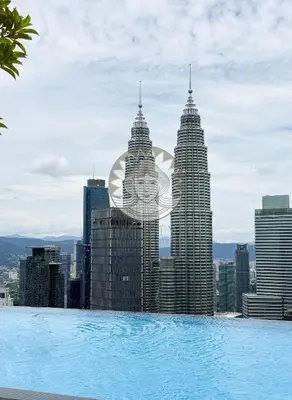 a view of the kuala lumpur city skyline from a pool at HOME STYLE at Platinum Suites 2 KLCC Twin Towers in Kuala Lumpur