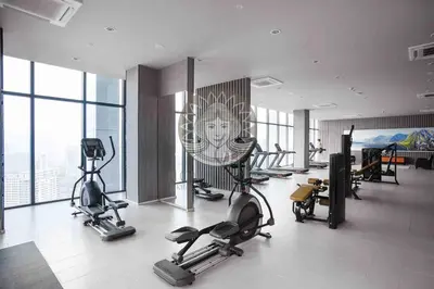 a gym with cardio equipment in a building with windows at HOME STYLE at Platinum Suites 2 KLCC Twin Towers in Kuala Lumpur