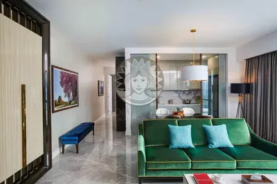 a living room with a green couch and a table at HOME STYLE at Platinum Suites 2 KLCC Twin Towers in Kuala Lumpur