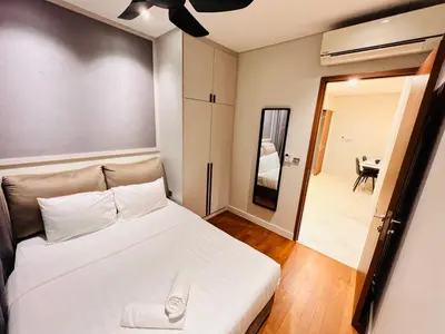 a bedroom with a white bed and a mirror at Sky Suites at KLCC by Mitstay in Kuala Lumpur