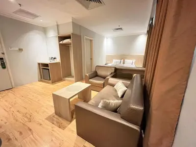 a living room with a couch and a bed at Sky Hotel Chow Kit PWTC in Kuala Lumpur