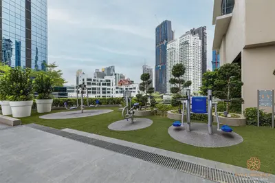 a park with a statue in the middle of a city at The Manor Residence KLCC by Five Senses in Kuala Lumpur