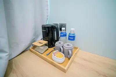 a wooden tray with coffee makers and water bottles at Kingston Hotel 8 - Kuala Lumpur Bukit Bintang in Kuala Lumpur