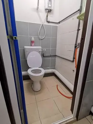 a small bathroom with a toilet in a room at Sri Rampai Metropolitan Hostel in Kuala Lumpur