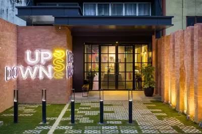 a building with a sign that reads up slow down at Upstairs Downstairs CoLiving Bukit Bintang in Kuala Lumpur