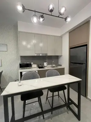 a kitchen with a table and chairs in a room at Agile Residence TRX Bukit Bintang by Cal in Kuala Lumpur
