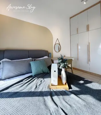 a bedroom with a large bed with a table at Residensi Trion in Kuala Lumpur