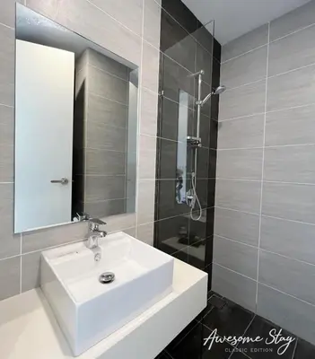 a bathroom with a white sink and a shower at Residensi Trion in Kuala Lumpur